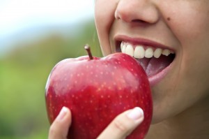 woman biting into an apple 