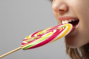 Girl eating sugar lollipop